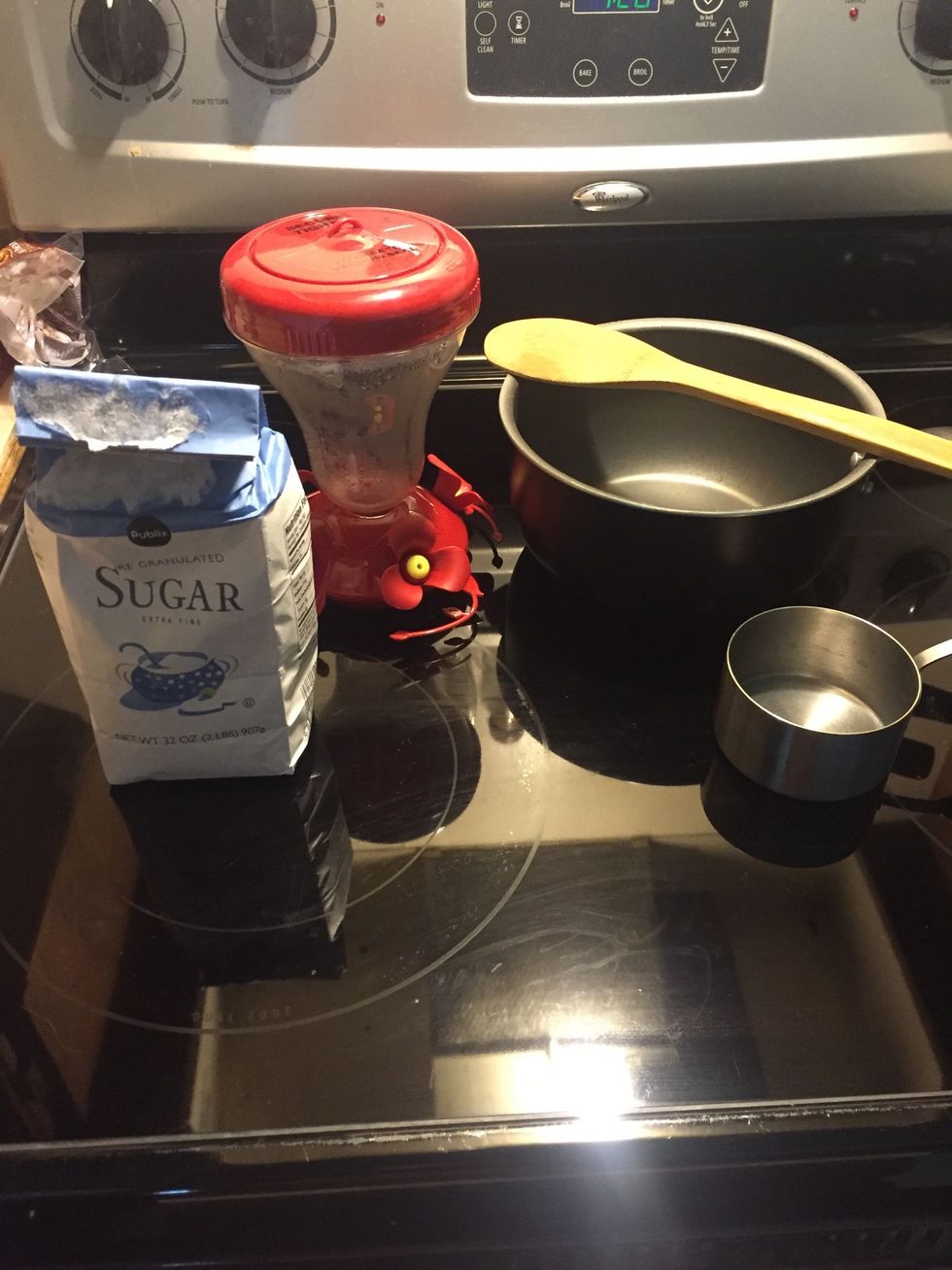 Gather supplies: cane sugar, clean pot and utensil, hummingbird feeder, 1 cup measuring cup.
