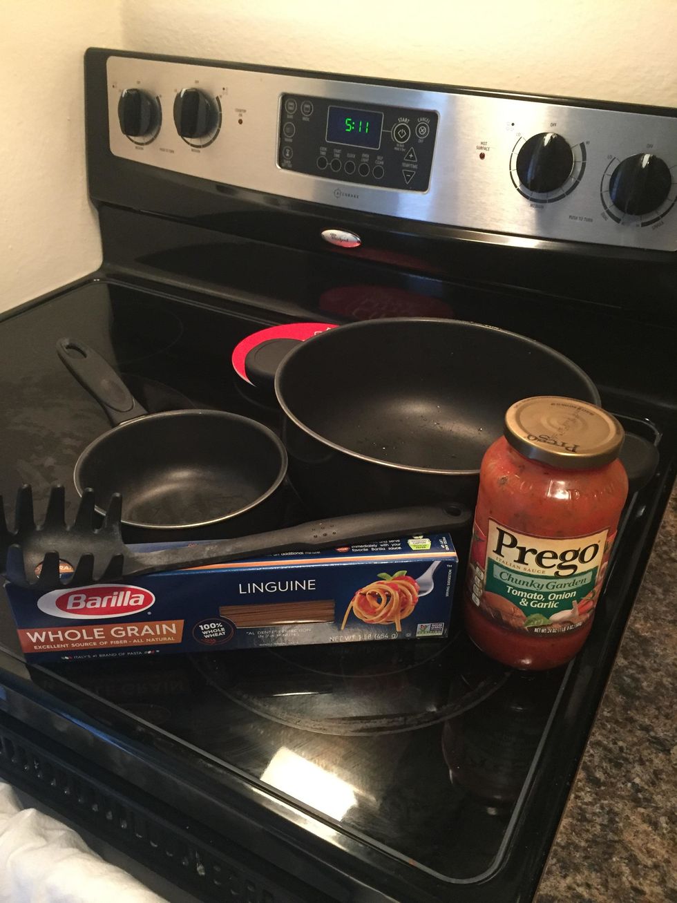 Gather supplies: large pot (6 quarts), small pot (1 quart), spaghetti spoon, spaghetti noodles, pasta sauce, strainer, potholders, small spoon, plate and fork