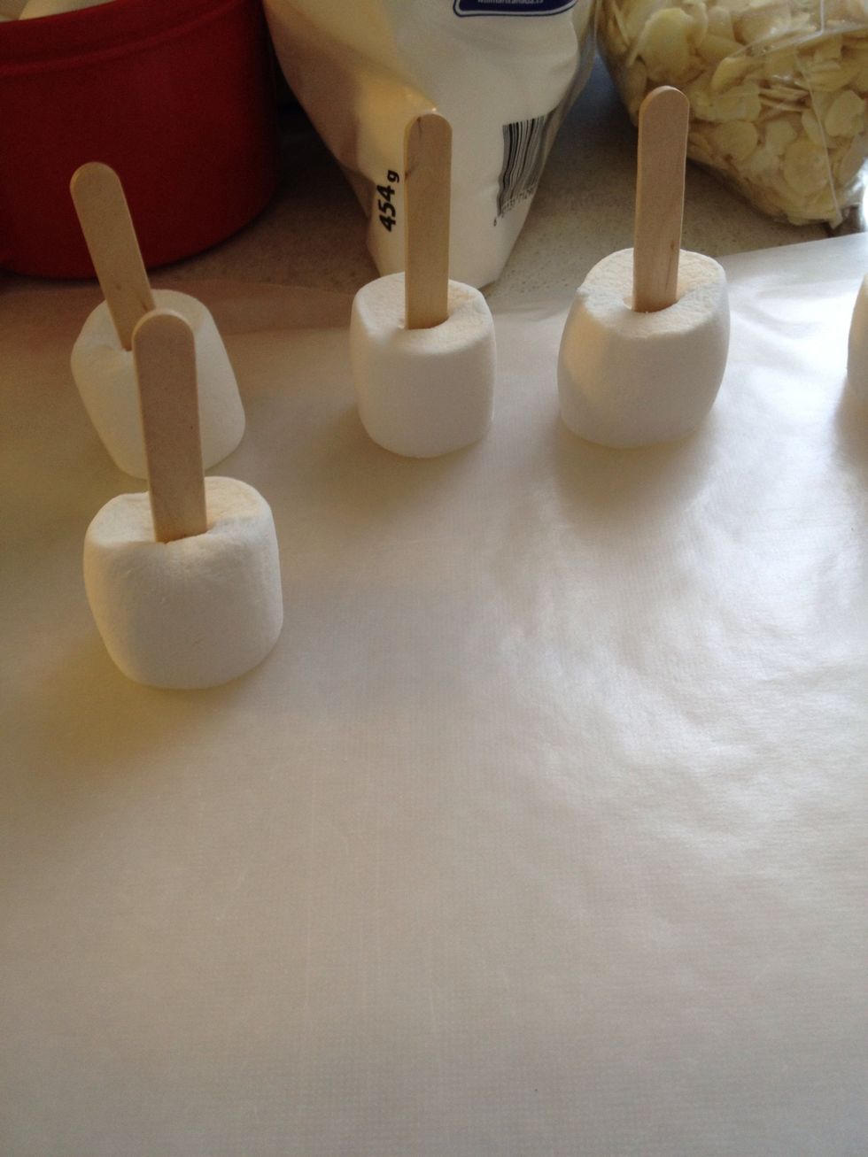 Gather supplies. While you got your chocolate chips melting in a double boiler start placing sticks in the mellows.