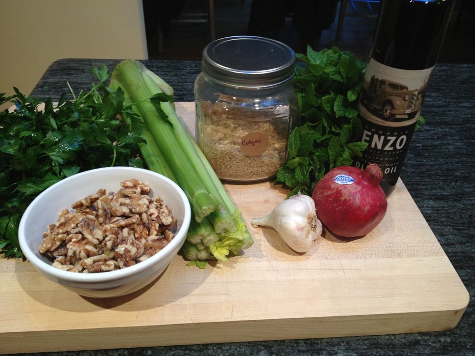 Gather the bulgar, walnuts, pomegranate, garlic, flat leaf parsley, mint, olive oil, salt and pepper.