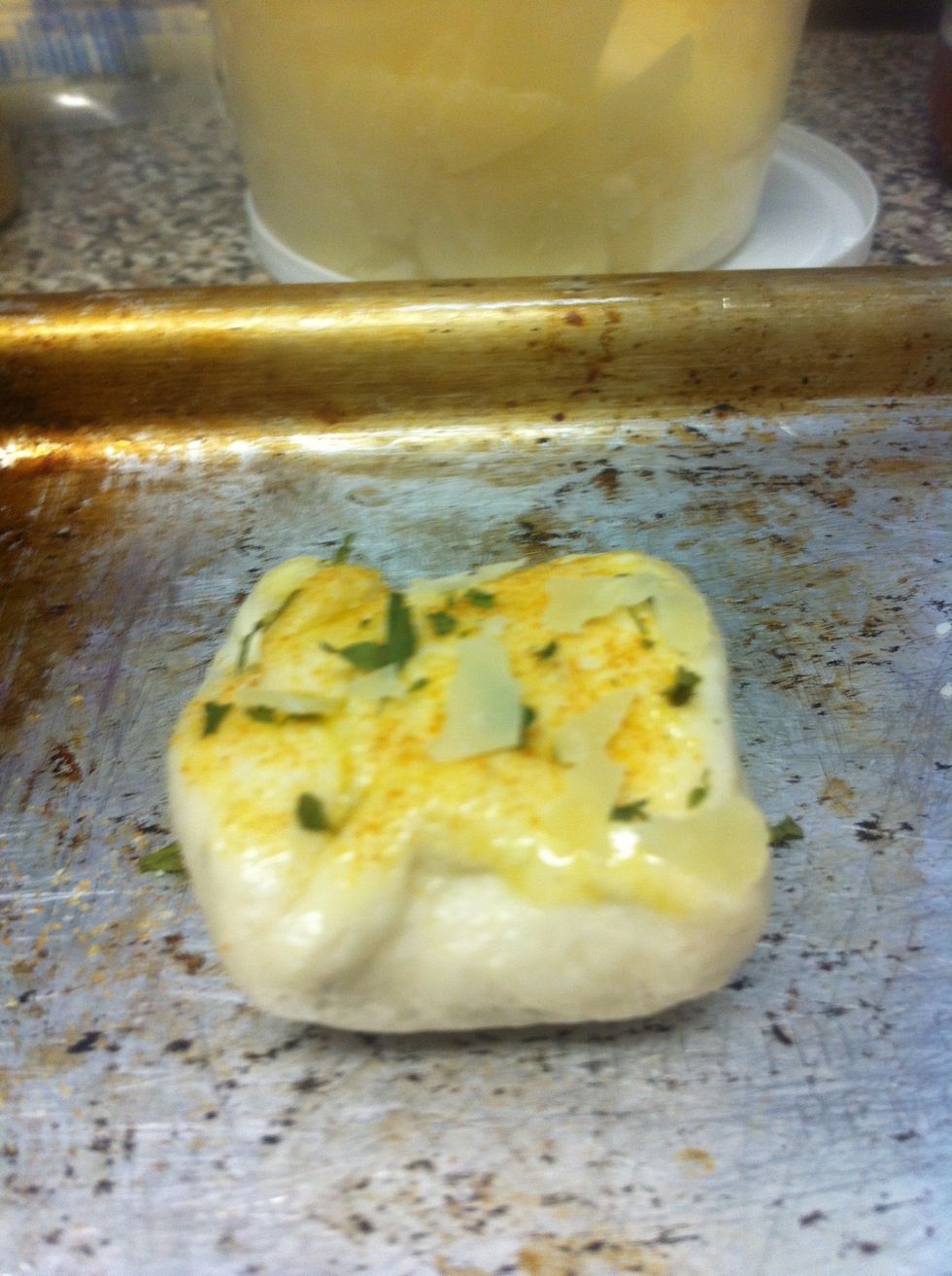 Gather the dough and form into a little bundle, and seal with an egg wash. Sprinkle with garlic powder, Italian seasoning, and Parmesan cheese. Bake at 450 degrees for abut 8-10 minutes.