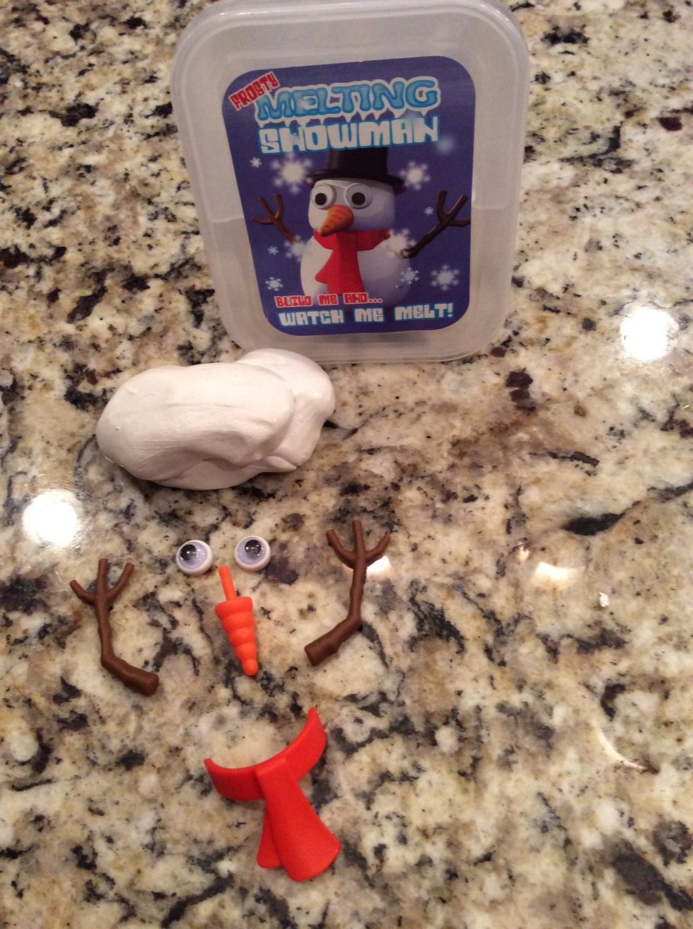Gather the melting snowman kit including white putty,to googley eyes,to stick arms,a plastic carot, and a plastic scarf !