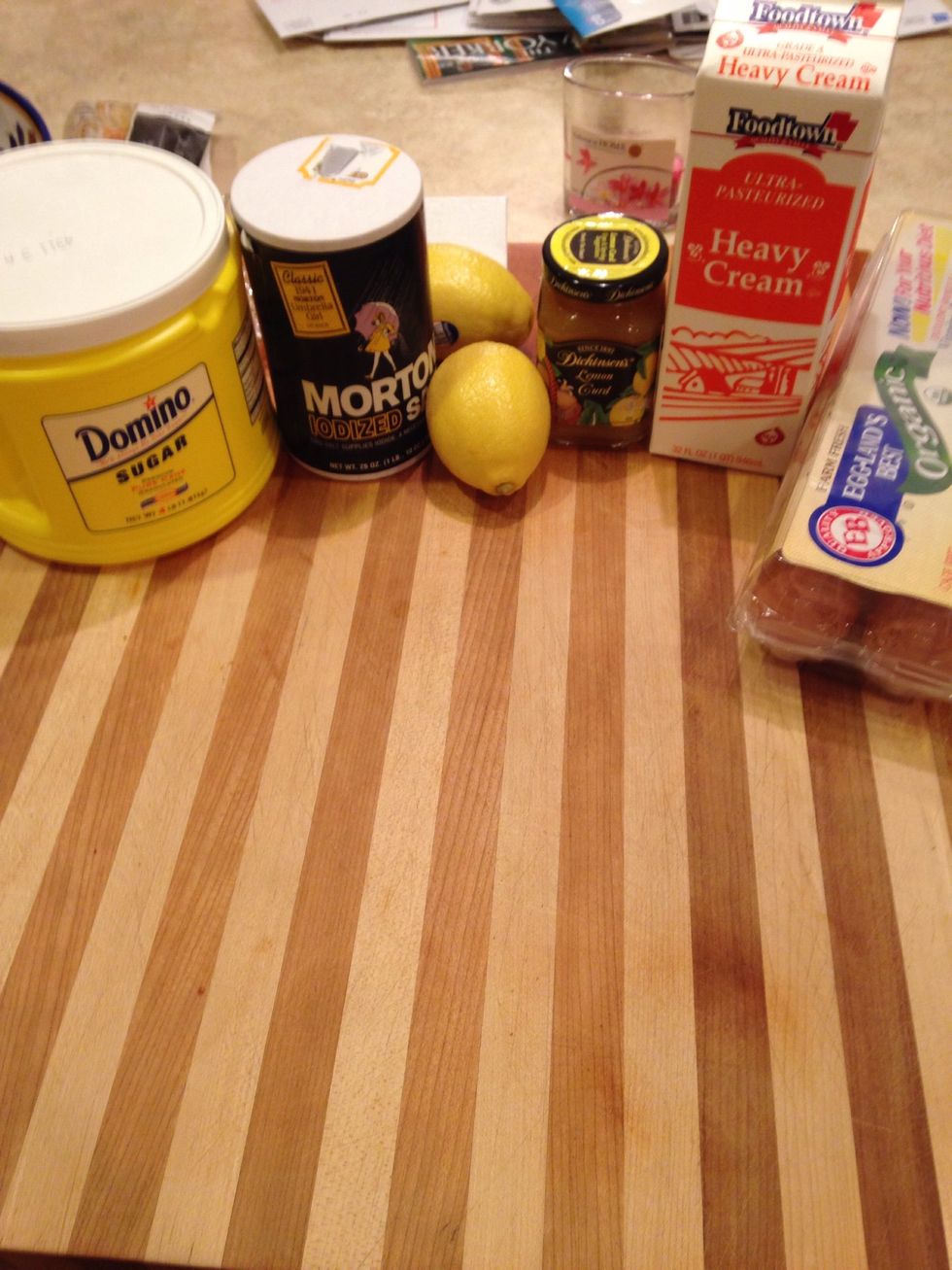 Gather the necessary Ingredients. In a large heat proof bowl, whisk together three whole eggs, three egg yolks, 1 cup sugar, the lemon zest, lemon juice, and a pinch of salt.