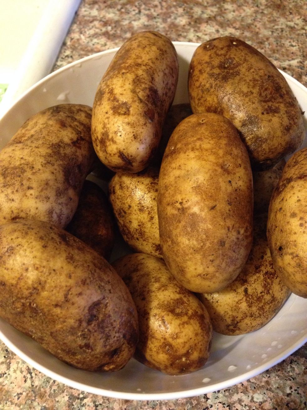 Gather the potatoes that you will be using for your salad. Rinse, then place in a bowl and prepare to peel.