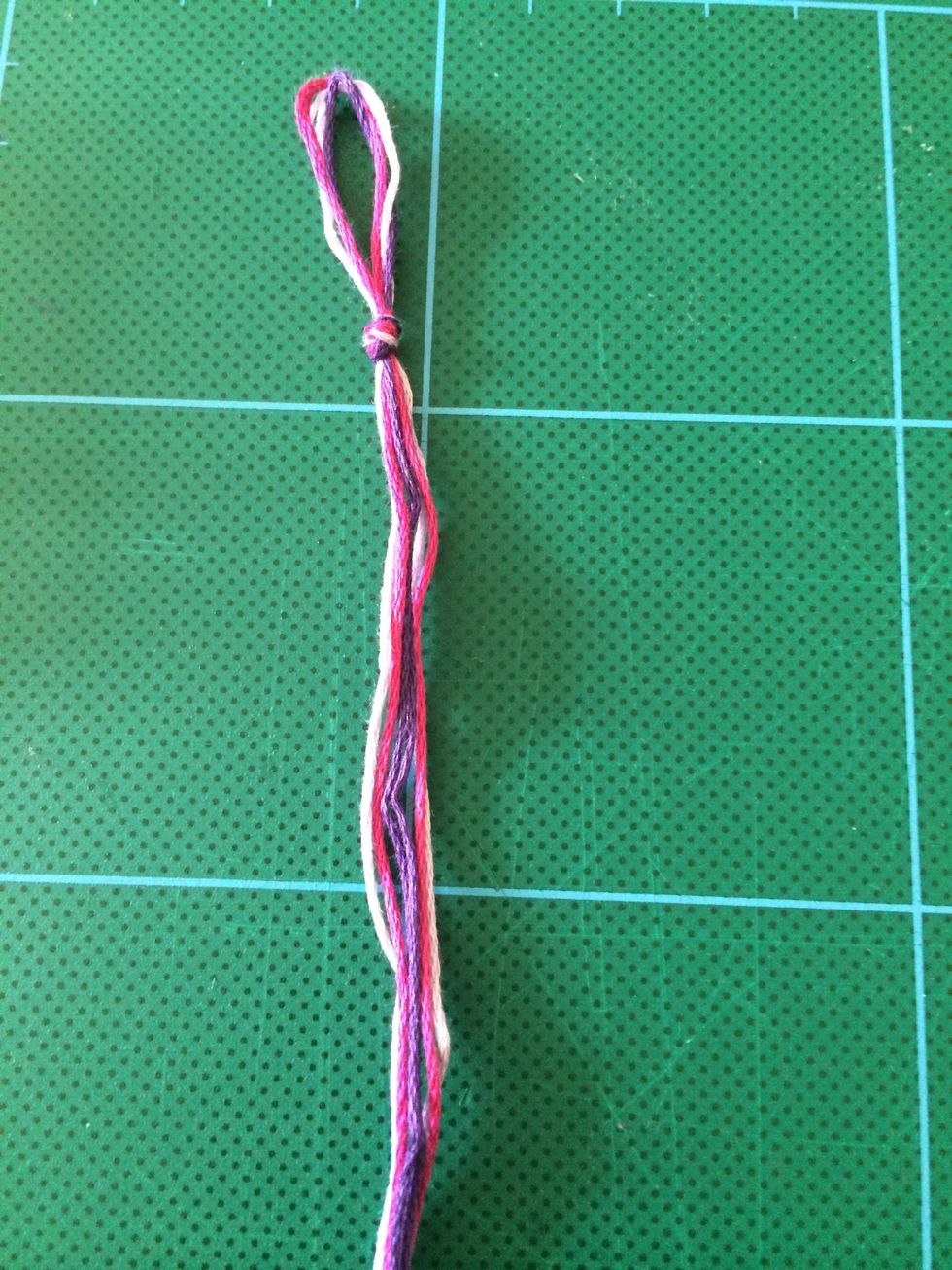 Gather the thread together and tie a knot near the loop.