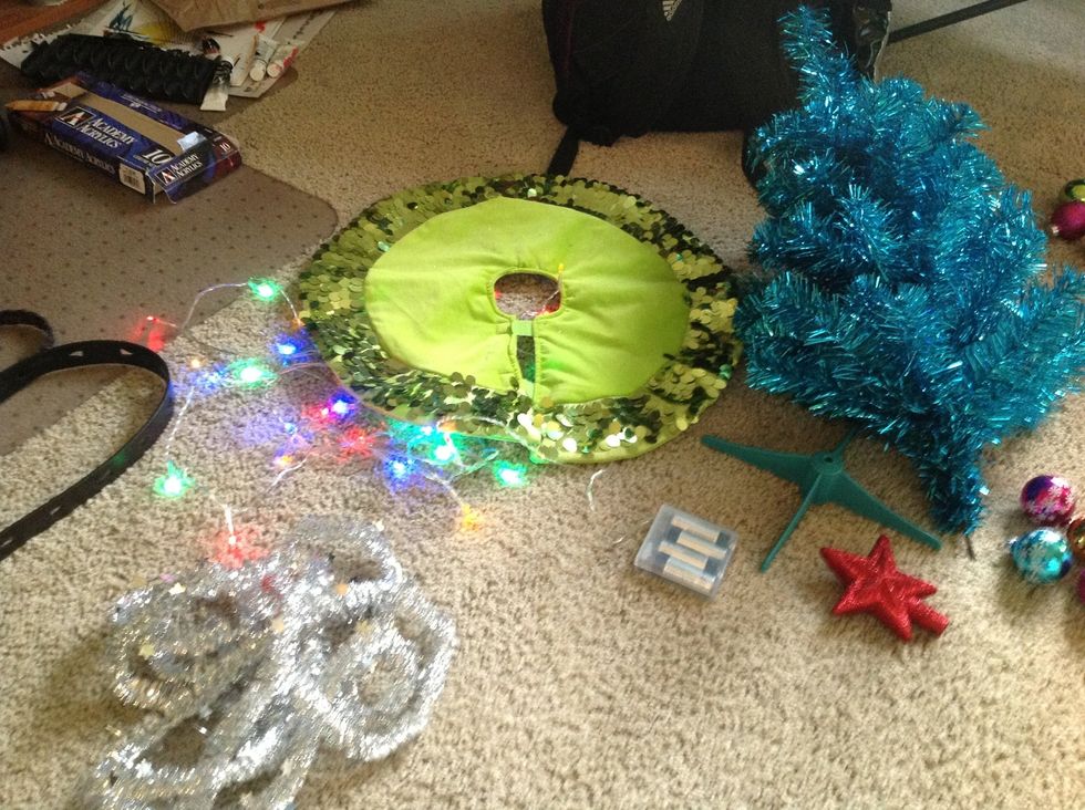 Gather tinsel type decoration, tree, ornaments, lights, tree skirt and candy canes.
