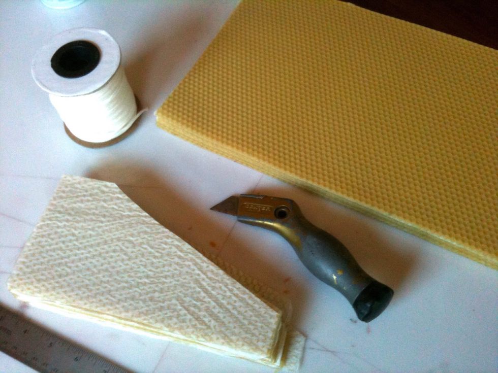 Gather wax, cutting board, Exacto knife, ruler and candle wick. 1 sheet of wax makes 2 candles. Purchase Beeswax online at beekeeping supply companies like Brushy Mountain, Dadant, or Mann Lake.