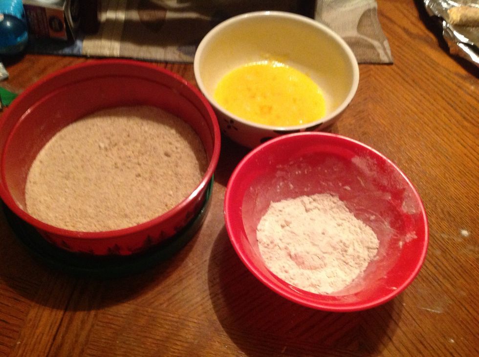 Gather your 3 bowls and beat the egg in one bowl, combine bread crumbs and Parmesan cheese and put in the other bowl, then put the flour in the last bowl.