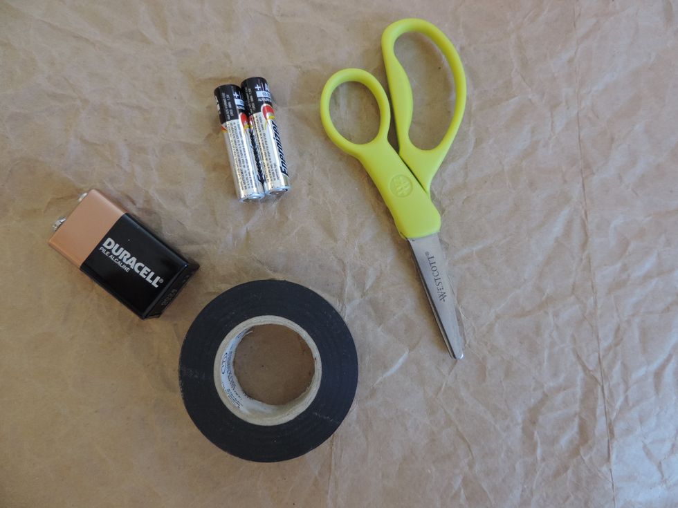 Gather your batteries, a pair of scissors, and electrical tape.