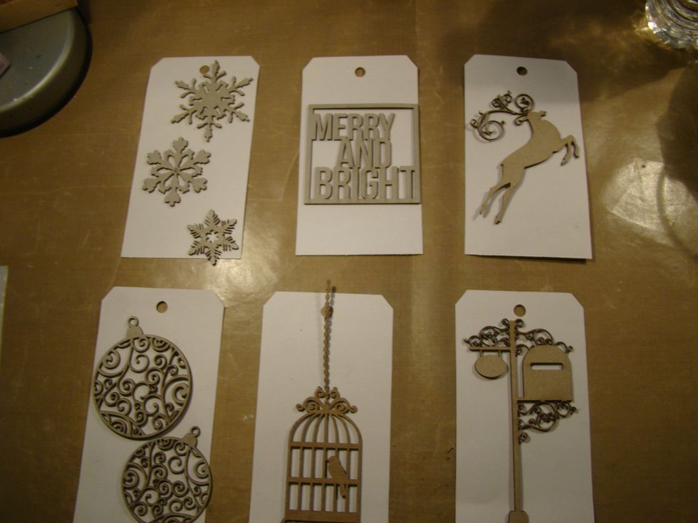 Gather your chipboard pieces and emboss them with your favorite color embossing powders. I used golds, patina and chocolate hues.