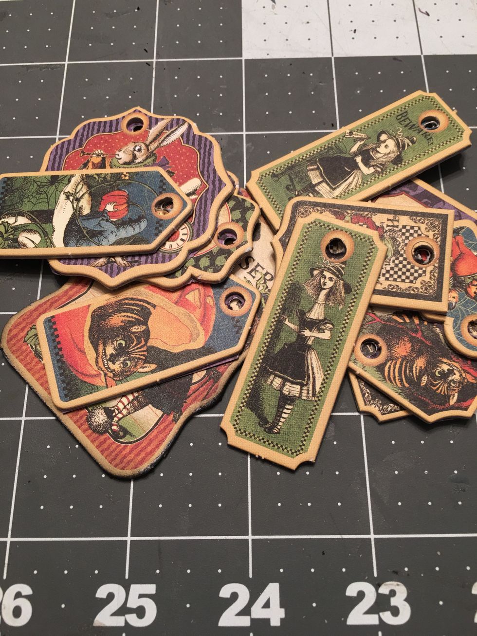 Gather your chipboard tags that you want to use in your mini album. Separate the ones that you want add to the ring of the ATC Tag Album. Prep all tags by sanding any rough edges and inking.