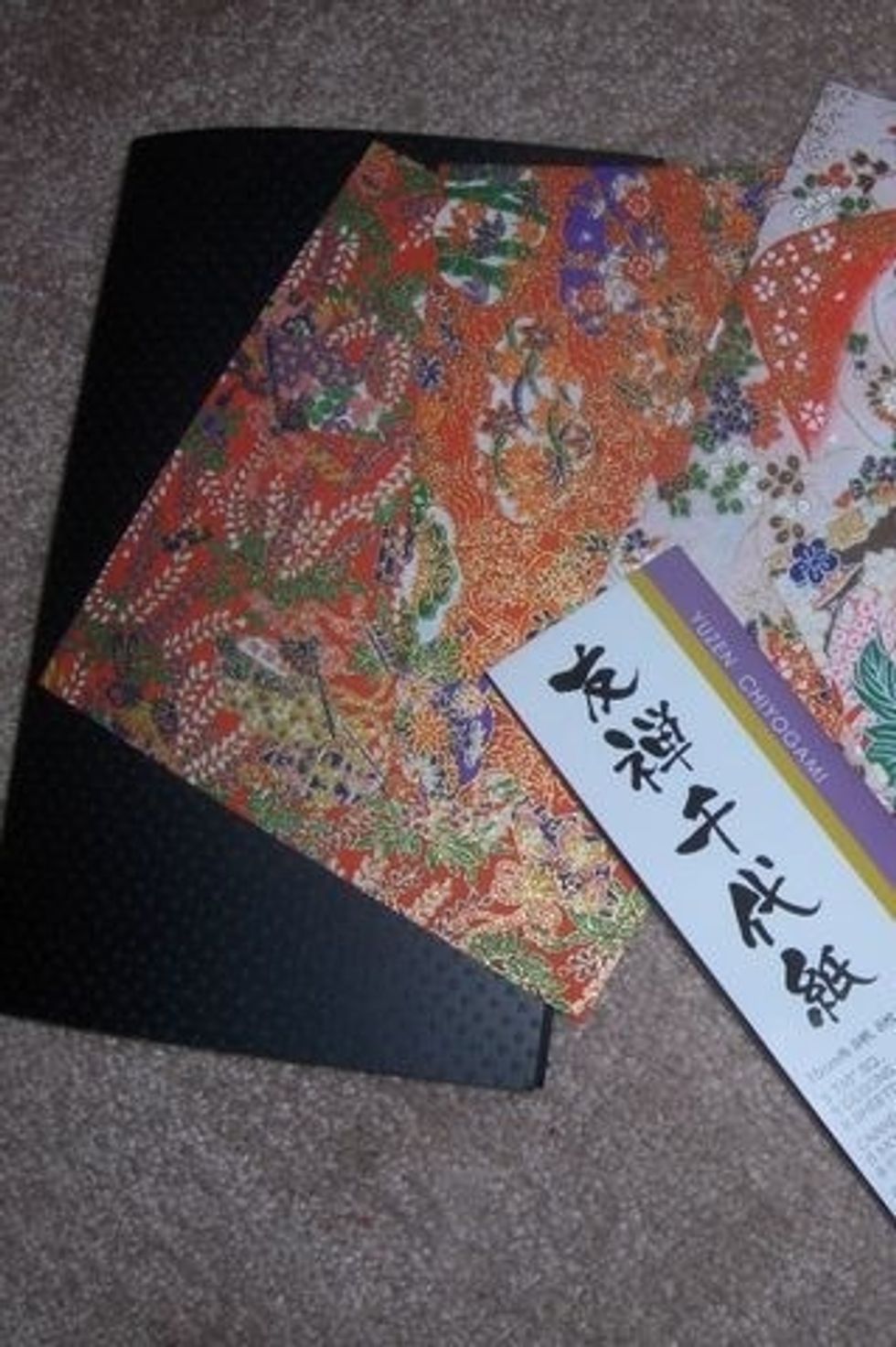 Gather your favorite colored paper- one sturdy sheet for the card itself, one for the inside of the card, and three or more sheets of origami paper for the hearts.