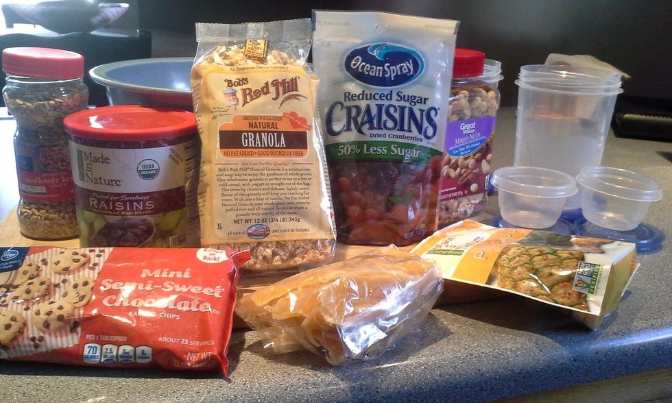 Gather your favorite ingredients for trail mix, starting with the base as Bob's Red Mill Natural Granola.  Choose your favorite dried fruits, nuts, seeds and sweet chocolates.