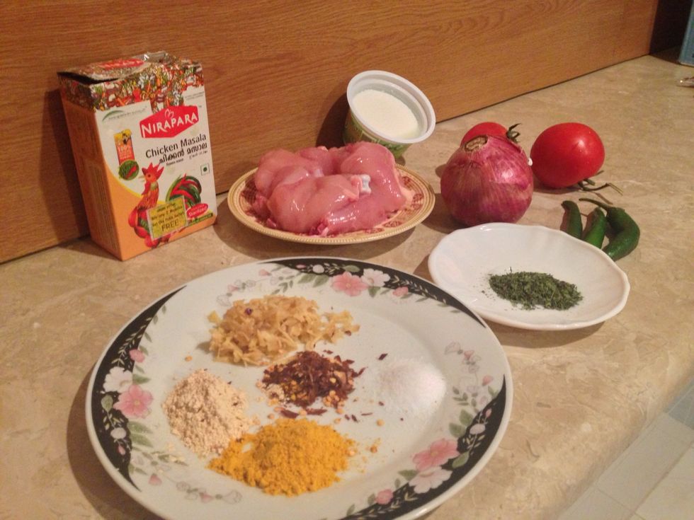 Gather your ingredients , Chicken, assorted spices, dried peppermint , masala, yoghurt , tomato , onion ,and green hot chilli.