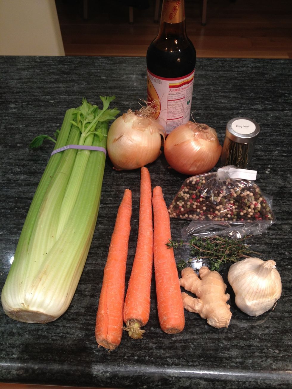 Gather your ingredients for the stock: celery, carrots, ginger, garlic, thyme, bay leaves onions, peppercorns and tamari.