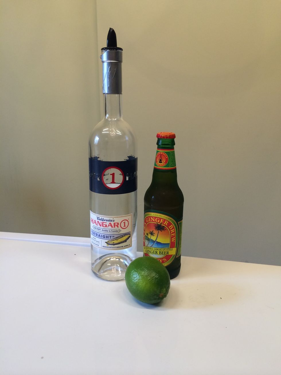 Gather your ingredients: ginger beer, vodka and lime.