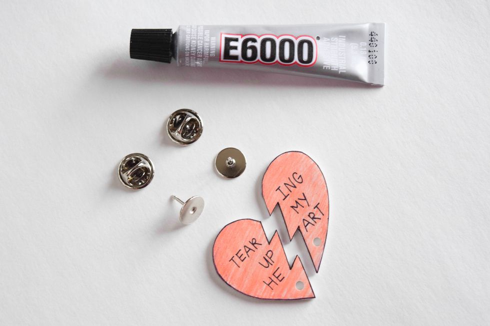 Gather your jewelry pins, E6000 glue, and shrink plastic pieces to assemble your pins.