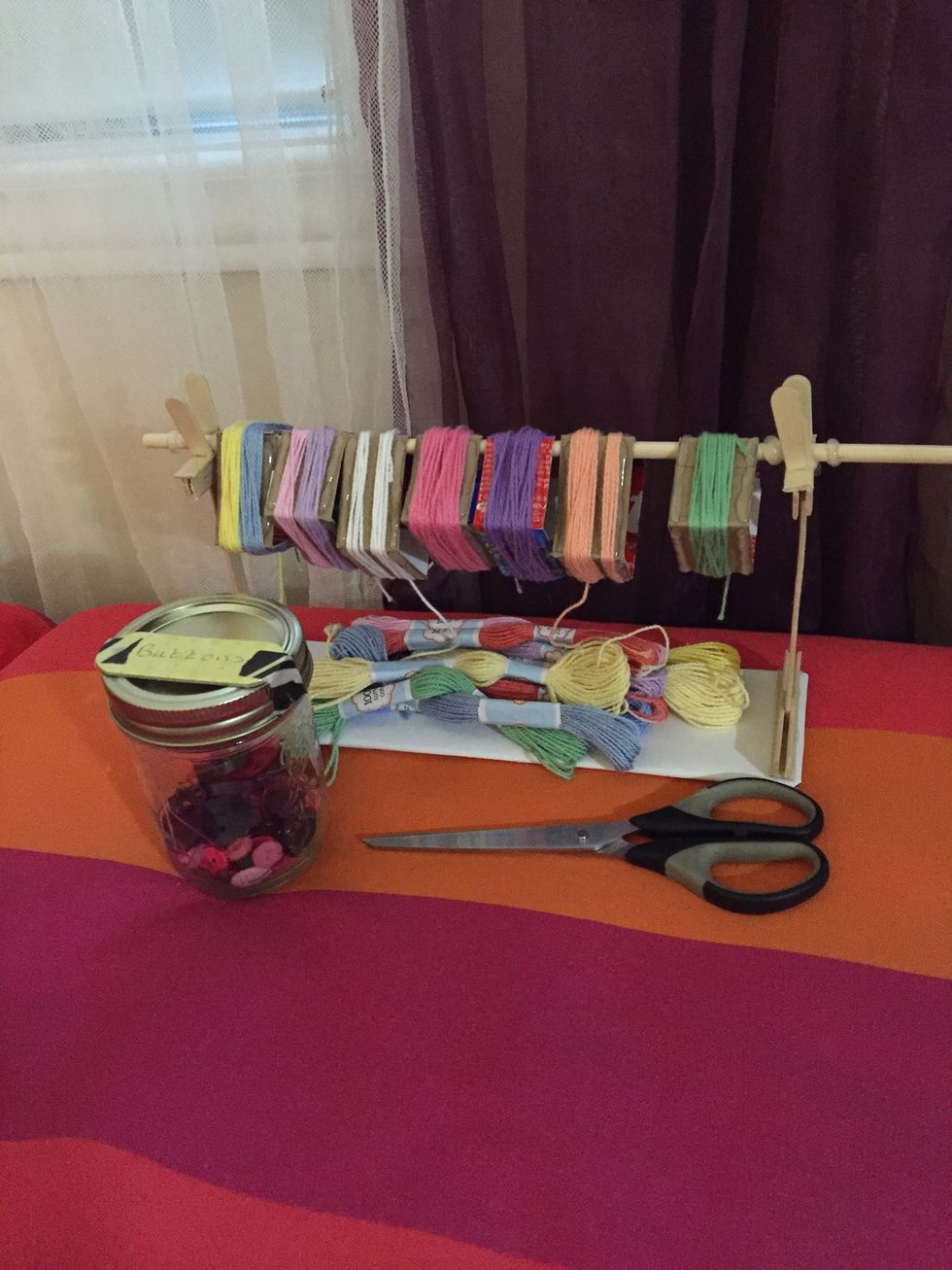 Gather your materials: string (I used embroidery floss), a button,scissors and tape