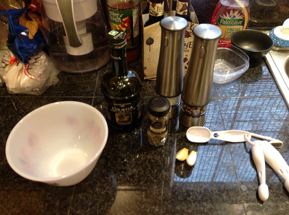 Gather your oil, garlic, and spices and get a small bowl. Peel and grate the garlic.