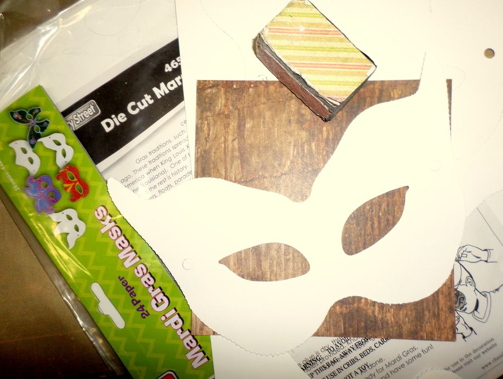 Gather your supplies for making your mask. I bought this pack of 24 masks at my local arts & crafts store for $3. Punch out the mask you want and use a sanding block to smooth the edges.
