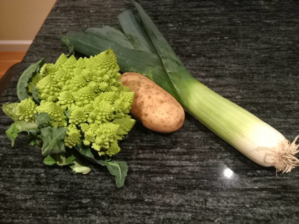Gather your three ingredients: a head of romanesco broccoli, a potato and a leek. Chop the potato into small cubes, break the broccoli into florets, and thinly slice the leak.