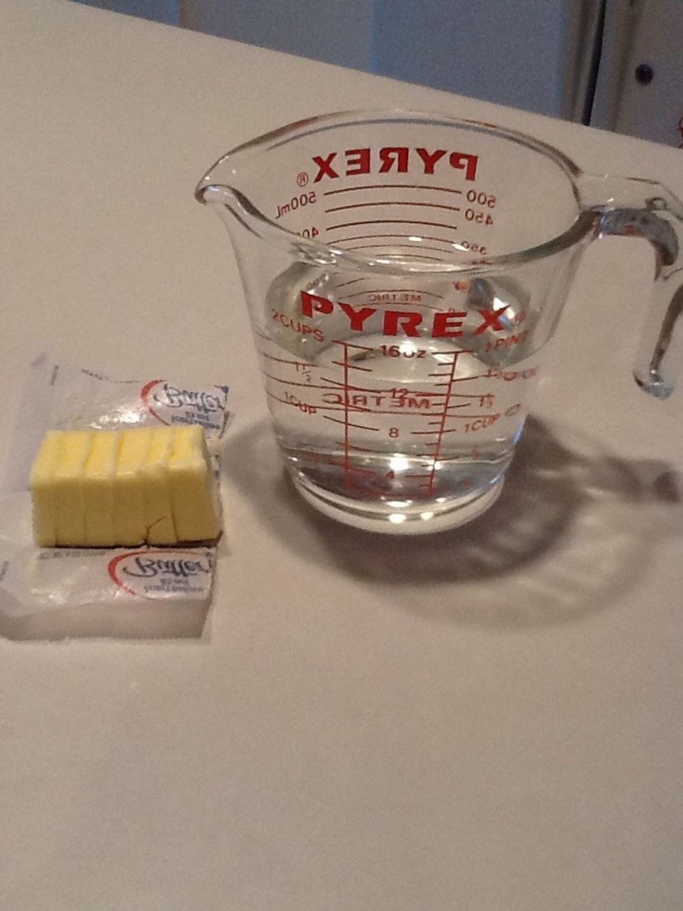 Gather your water (1 2/3 c.) and butter (4 tbsp.). Slice the butter into smaller chunks.