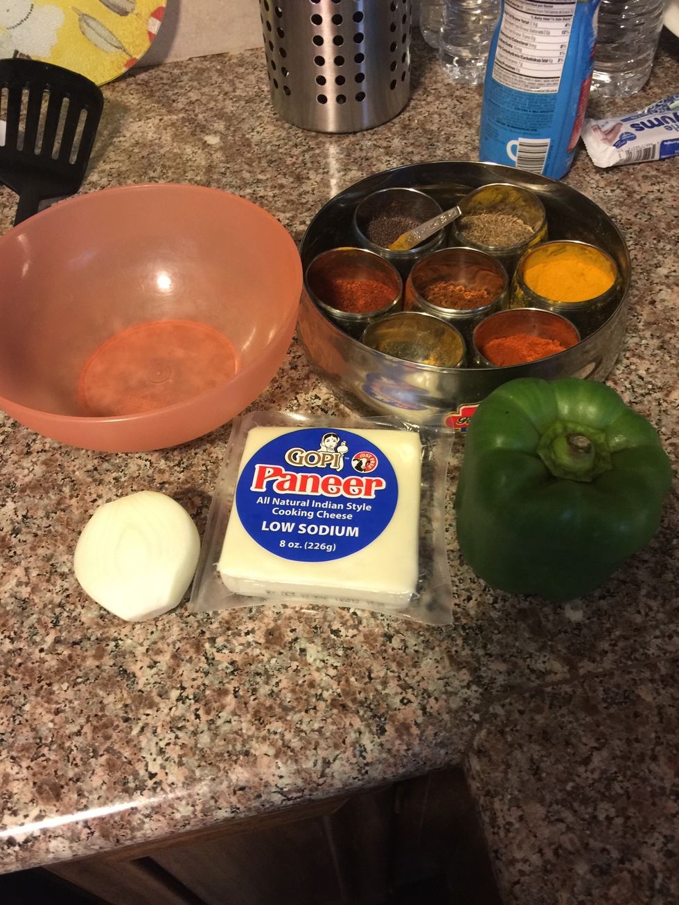 Gayher your supplies. Paneer/ cottage cheese, spices, onion, capsicum.