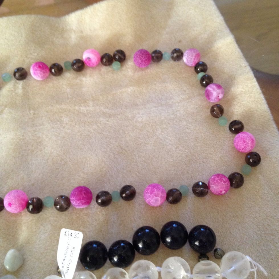 Gemstones off your choice - I'm using smokey quartz, pink cracked agate and green apitite. Lay out your design before threading.