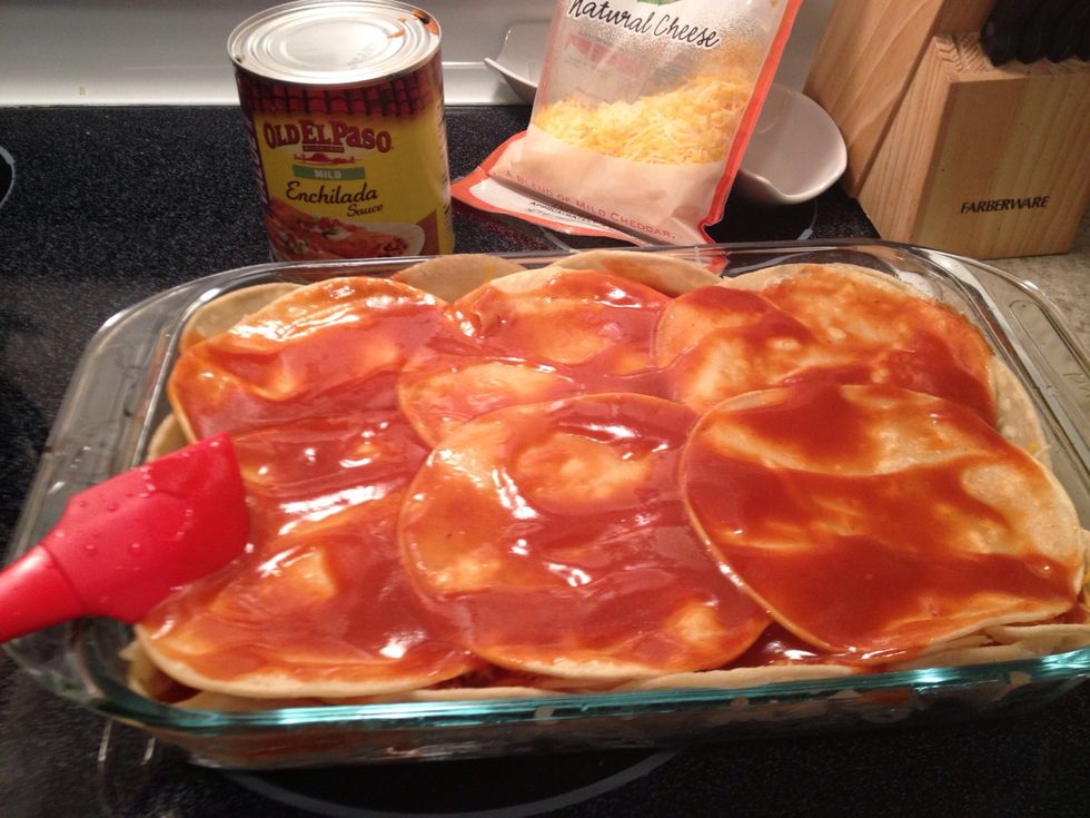 Generously spread your enchilada sauce then repeat the mixture layers, cheese and tortillas until your dish is filled to the top