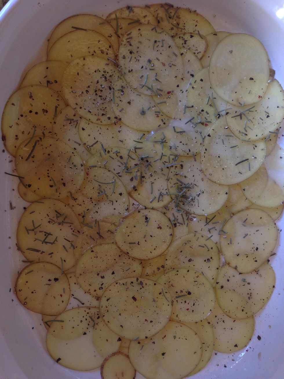Generously, sprinkle rosemary, black pepper and sea salt over the layer of potatoes. The amount really depends on how much flavor you like. Remember, you will do this three times.