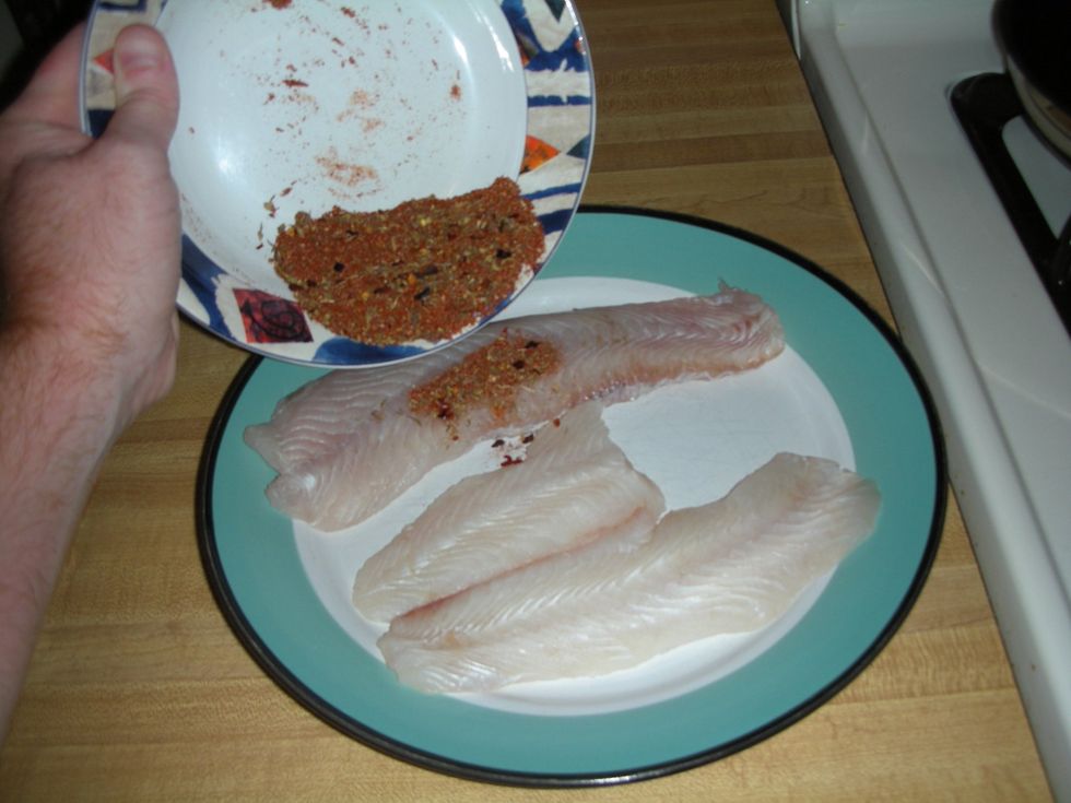 Generously sprinkle the first side of both fillets with the spice mix.   Rub into fluke.  Then flip fillets and repeat.