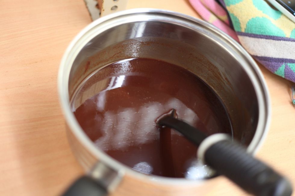 Gentle very low heat and continuous stirring of your butter and chocolate until there's no more butter visible in your chocolate. And we really mean continuous stirring.