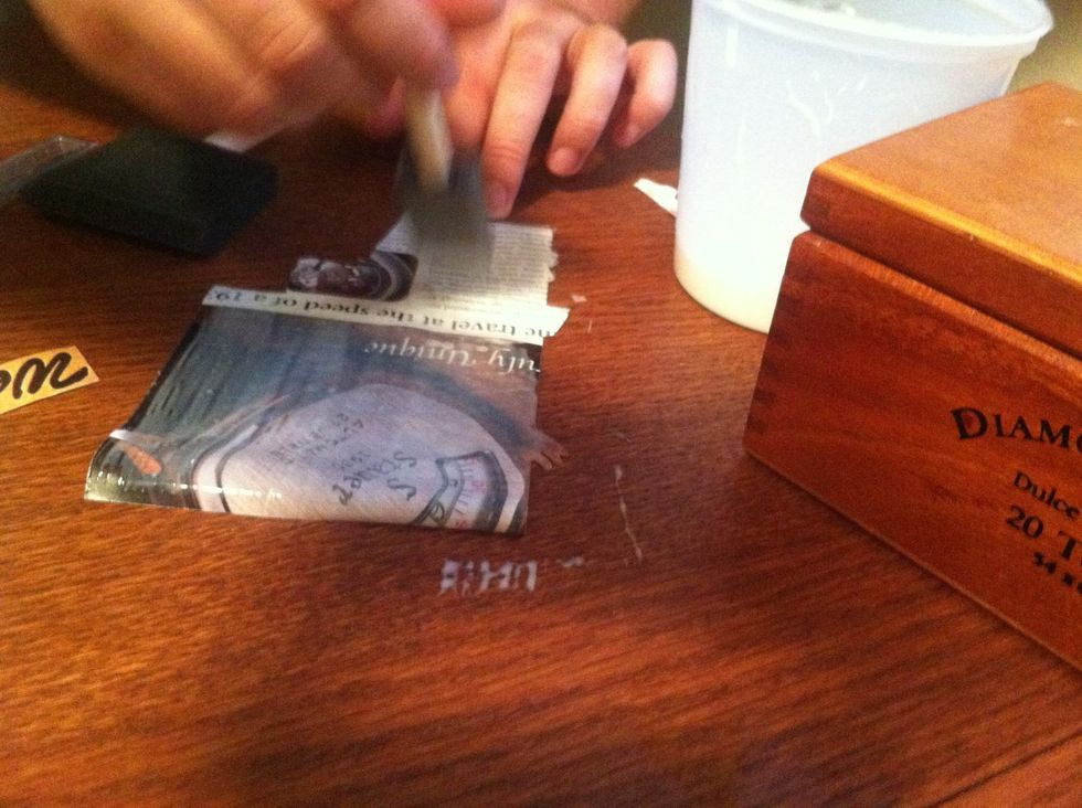 Gently apply glue solution to the back of clippings. The paper will curl and become flimsy, so be gentle.