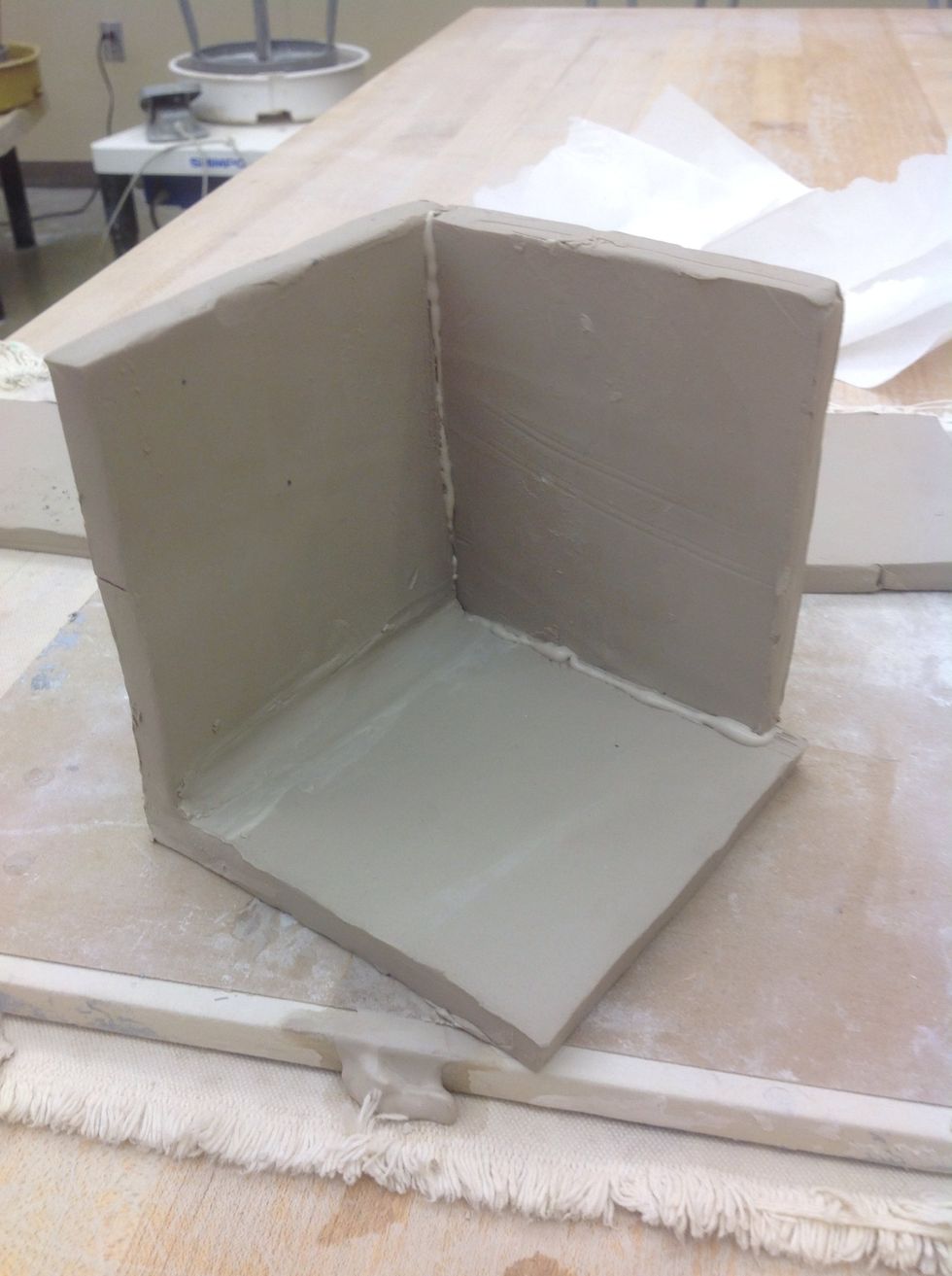 Gently but firmly press the B piece to the corner of the two A pieces. Stitch the B piece in.