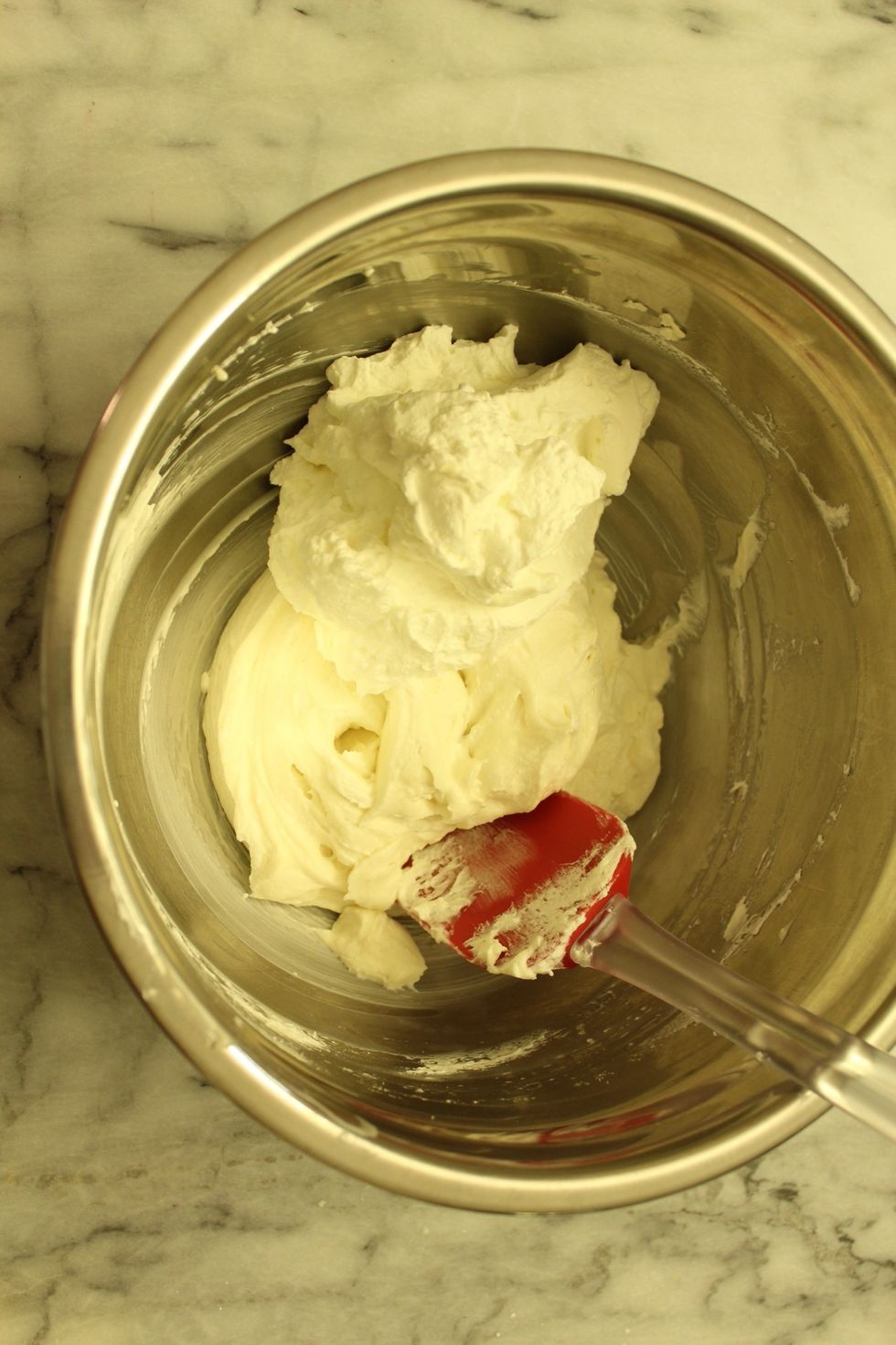 Gently but thoroughly fold the whipping cream into your cream cheese mixture.
