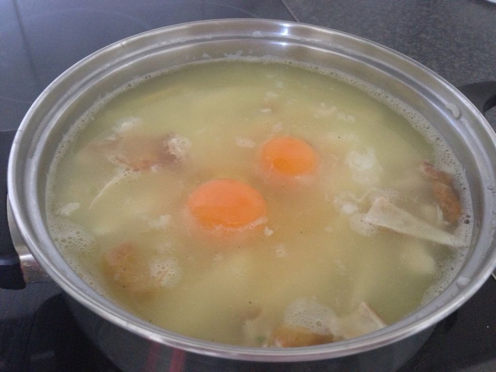 Gently cover the eggs with soup and rice from the edge to help with the cooking process. Take care not to break the eggs whilst doing so.