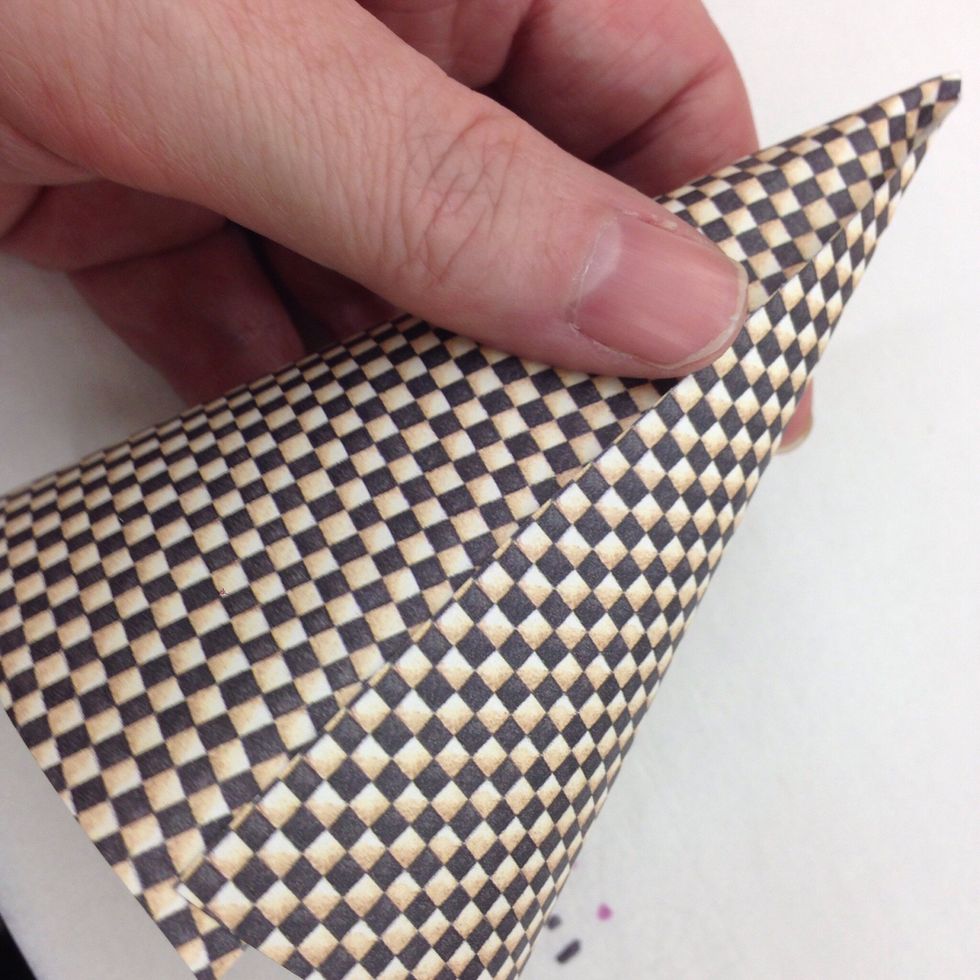 Gently curl the roof into a cone shape. Peel the paper backing off the double stick tape and secure it to the other side of the roof.