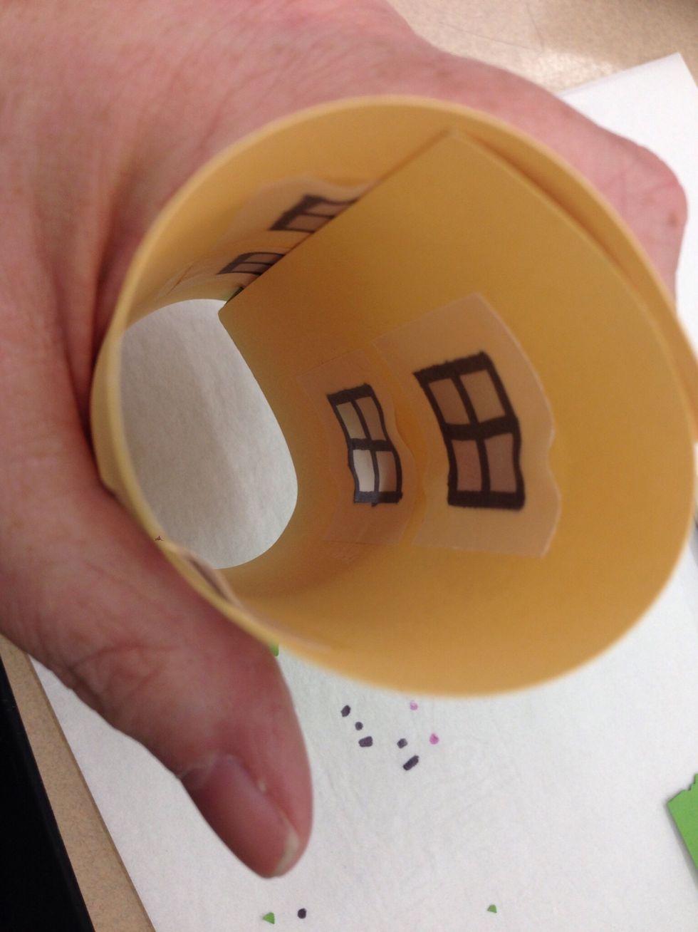 Gently curve the house into a cylinder shape. Peel the paper backing off the double stick tape and secure it to the other side of the house.