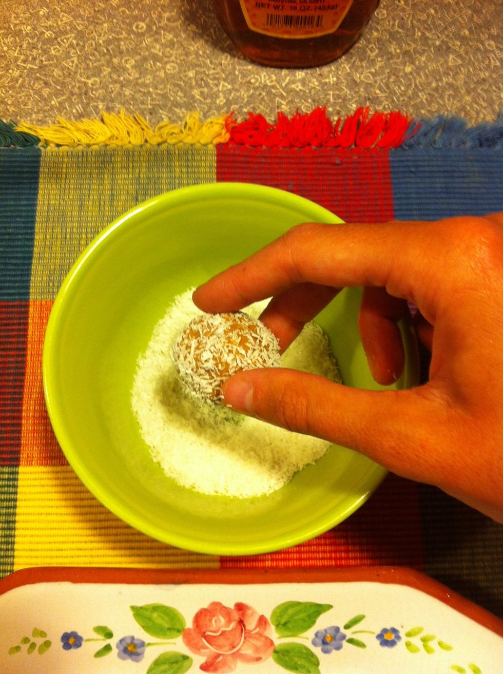Gently dip each ball into the shredded coconut and cover the entire surface.