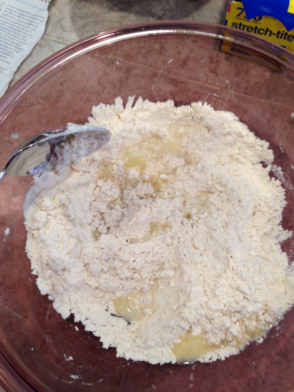 Gently draw flour mixture into butter mixture until moist clumps form.