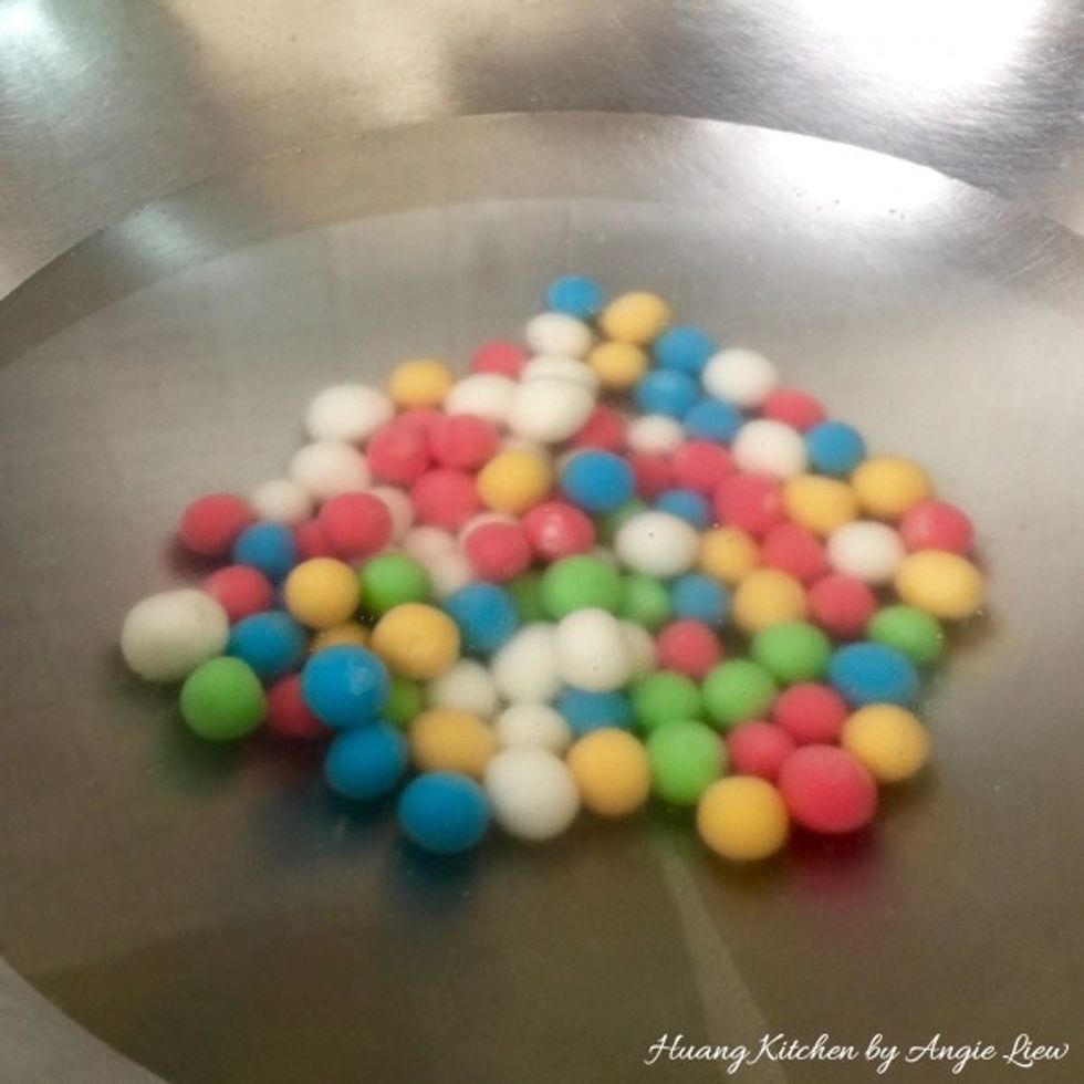 Gently drop the rolled glutinous rice balls into the boiling water.