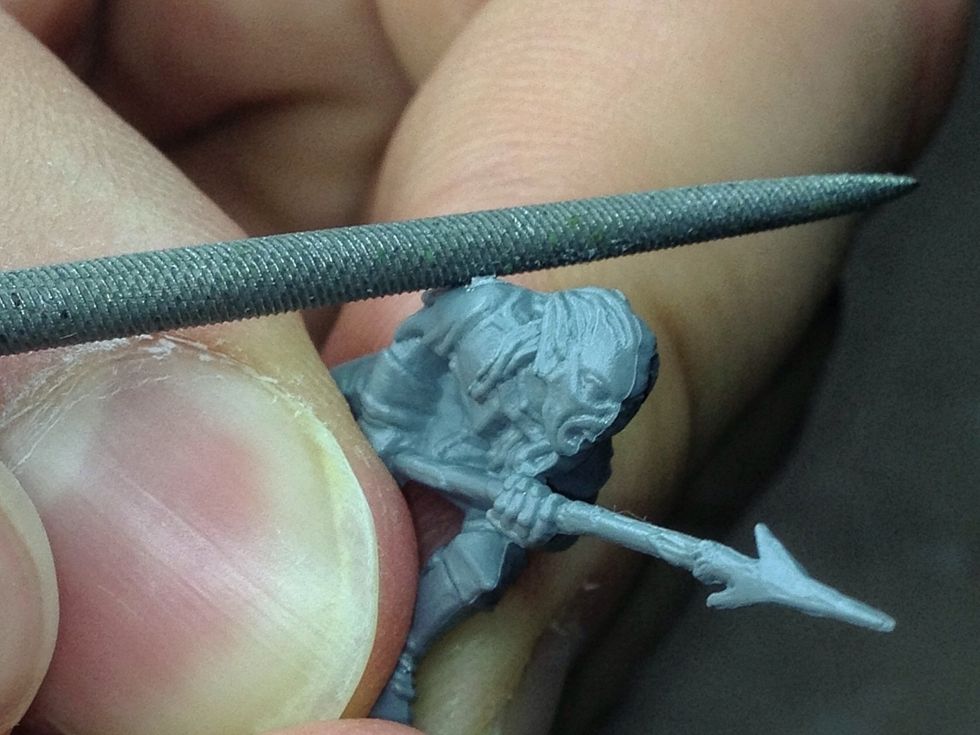 Gently file this blemish until it is gone using the round file. Be careful not to damage the details on the model when doing this.