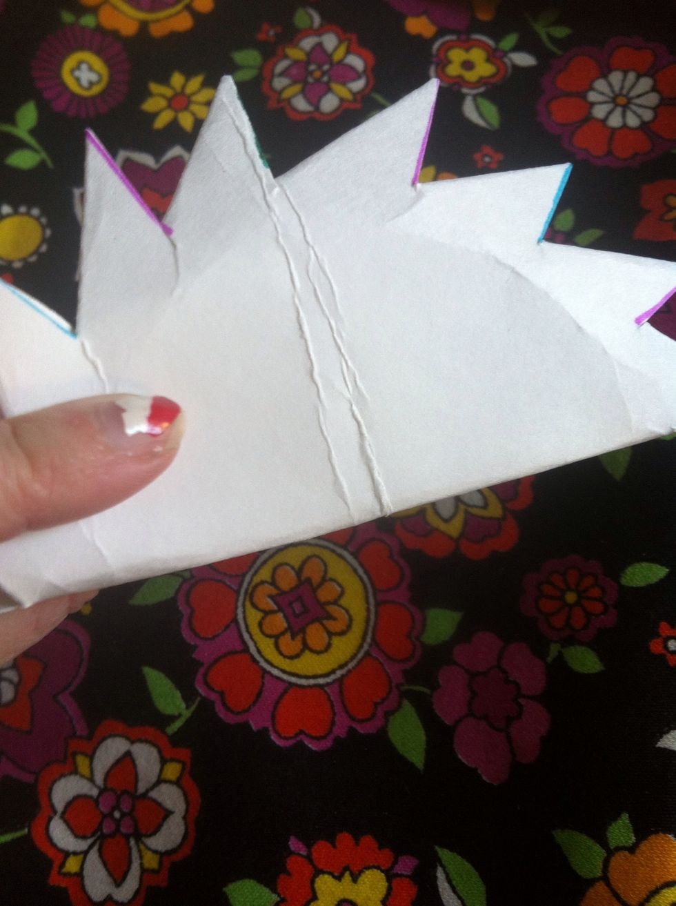 Gently fold in half, so when you open it there will be cross in middle.