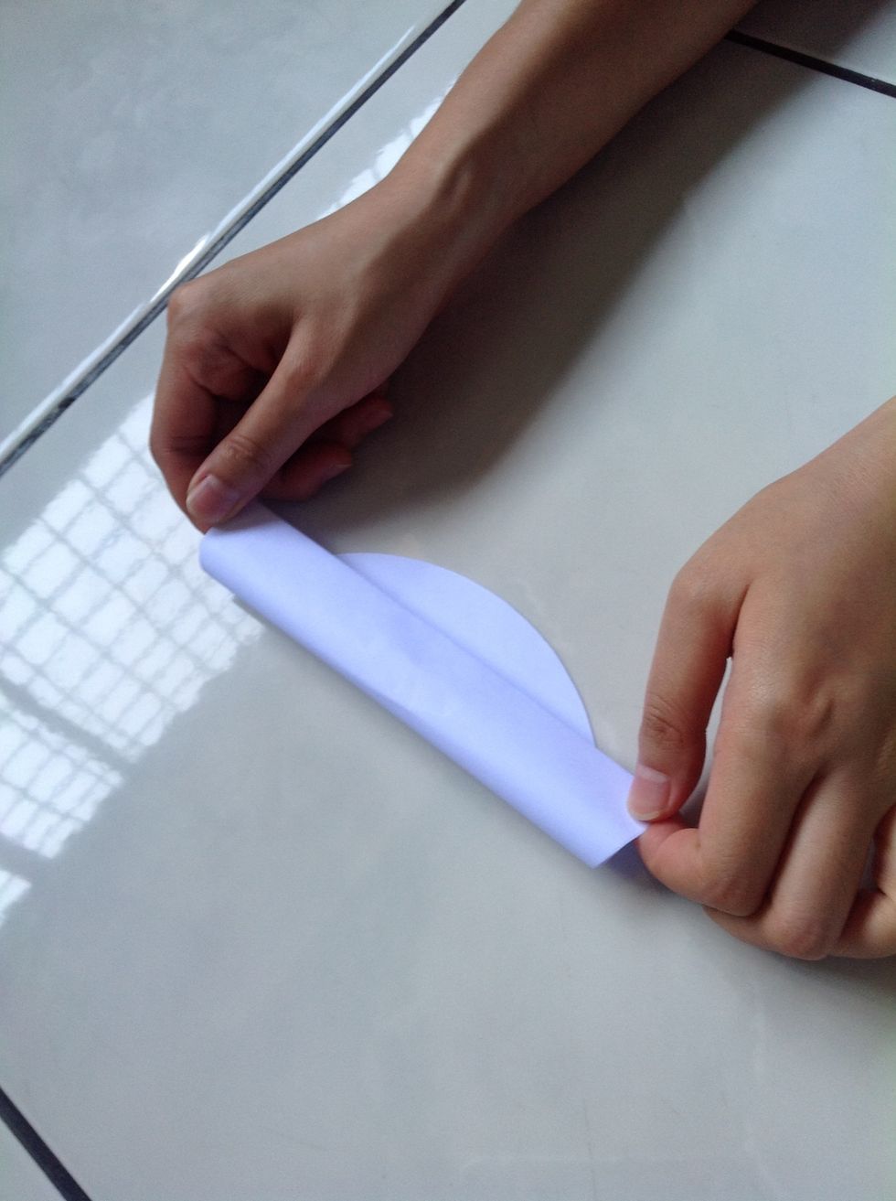 Gently hold the paper into the position shown
