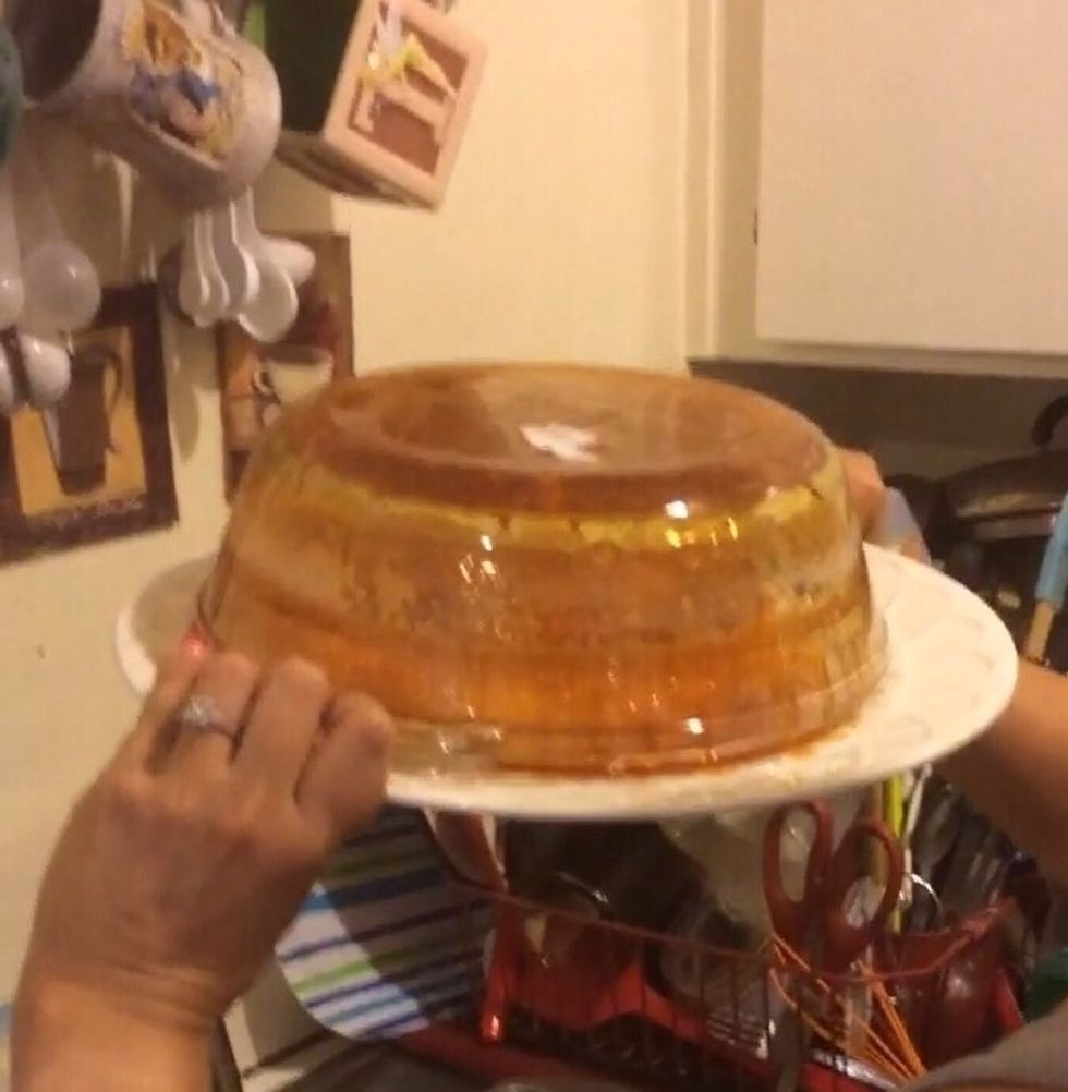 Gently jiggle it a little bit to ensure flan is centered. WARNING: this may make a mess so be prepared. First time I did it, I did it over the sink and some caramel splattered on my wall