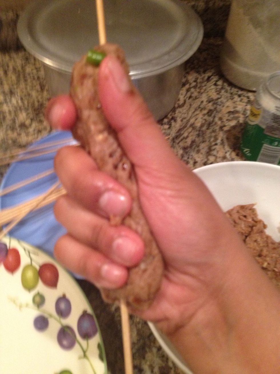 Gently knead the mixture rolling it in your hands and spreading the meat evenly in both directions