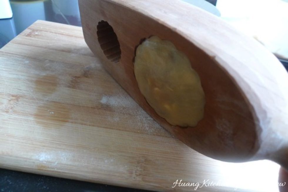 Gently knock a few times to dislodge the moulded mooncake.