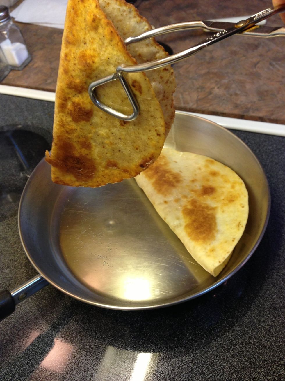 Gently lift, keeping tortilla folded. Let excess oil drip into pan