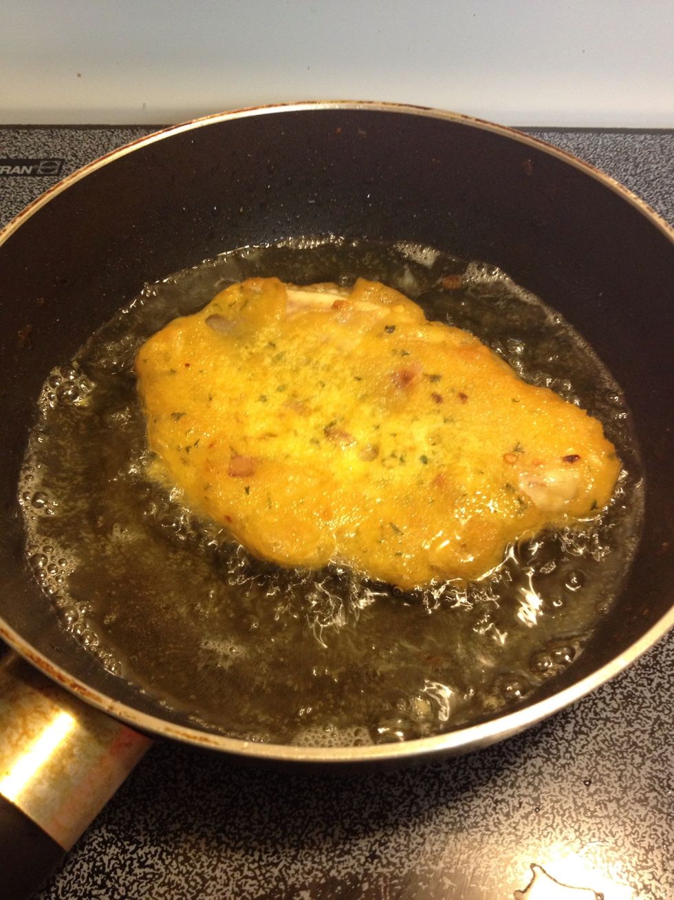 gently lower it into the oil. Fry until lightly browned below; switch sides.