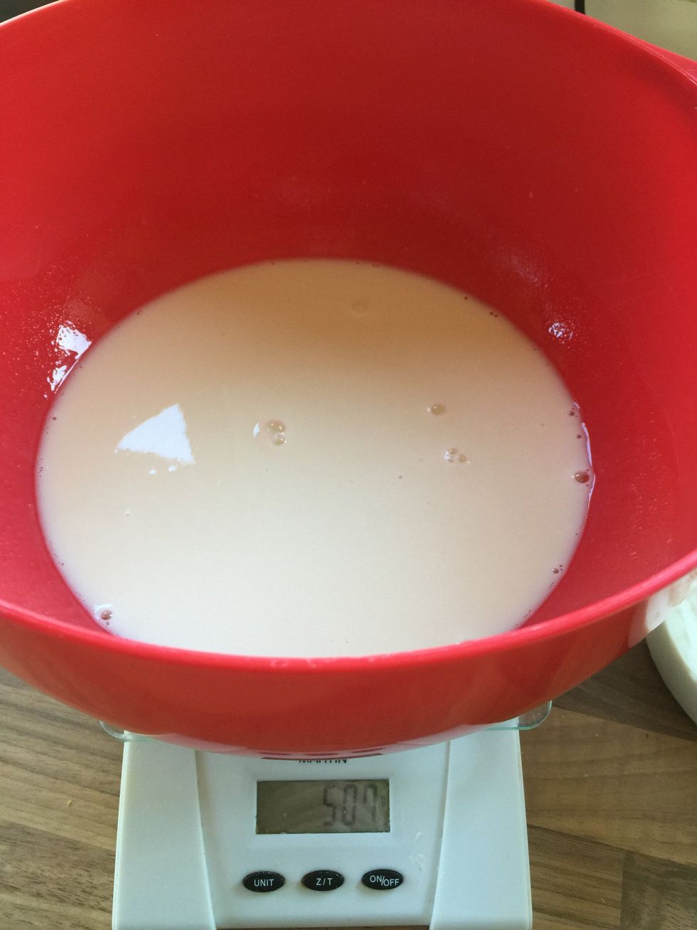Gently mix the water and starter together in the bowl.